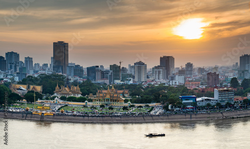 Phnom Penh river cruise boat passing the Royal Palace,at sunset,Cambodia.