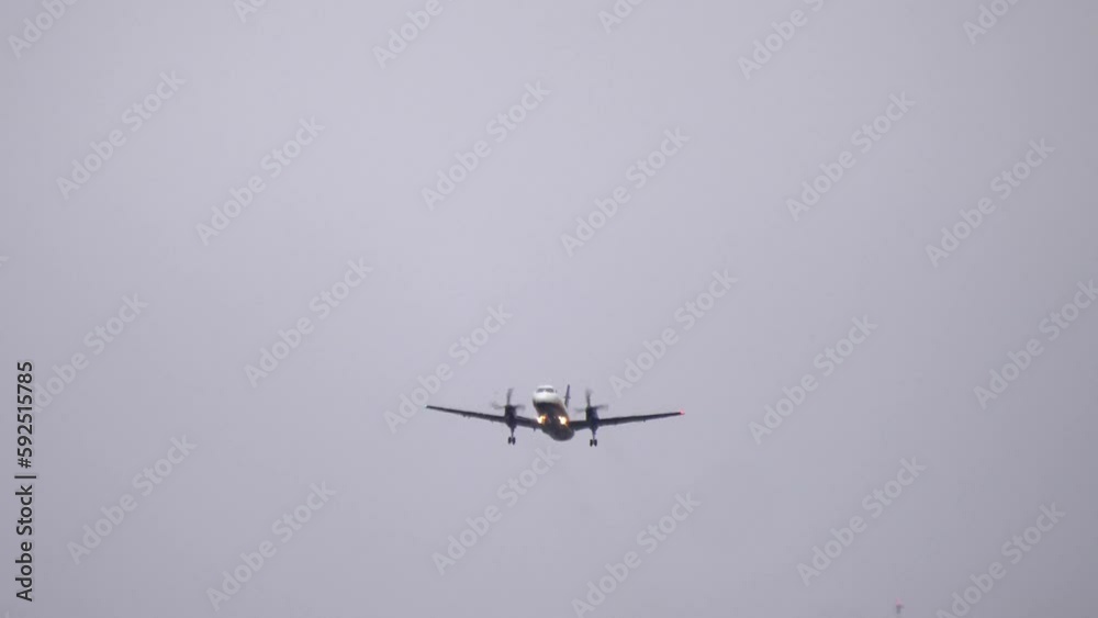 A Saab 2000 Turboprop Passenger Airliner Taking Off on a Cloudy Day. A Saab 2000 Turboprop Passenger Airliner Taking Off on a Cloudy Day.