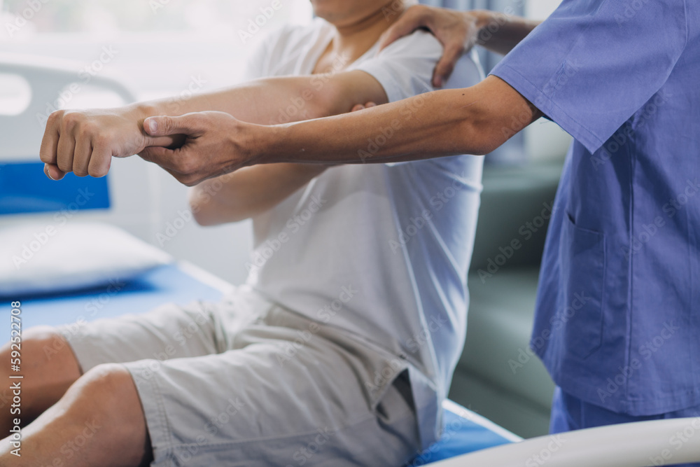 Physiotherapist working with patient in clinic, closeup Physiotherapist working with patient in clinic, closeup