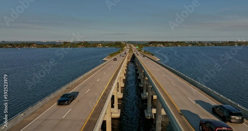 Merritt Island Florida Aerial v8 cinematic drone flyover Indian river, flying straight above Pineda Causeway capturing commuters traffics on the road bridge - Shot with Mavic 3 Cine - March 2022 photo