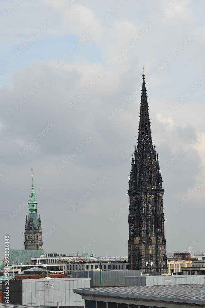 Old church tower of the St. Nikolai under the cloudy sky in Hamburg