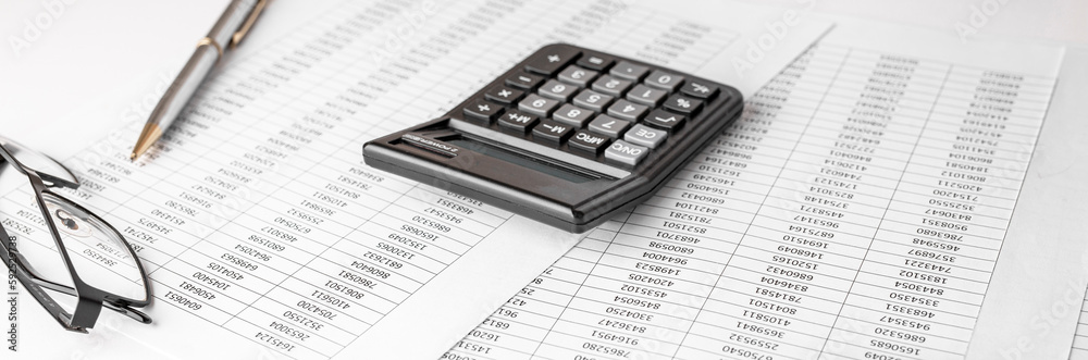 Calculator on financial statement and balance sheeet on desk of auditor. Concept of accounting and audit business. Calculator on financial statement and balance sheeet on desk of auditor. Concept of accounting and audit business.