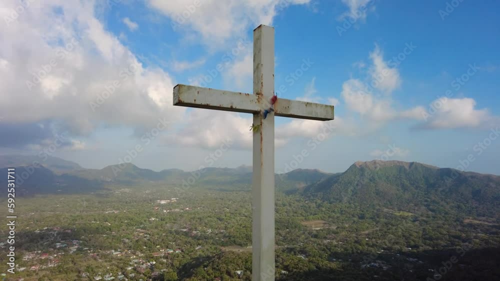 A towering crucifix perched atop a majestic mountain, surrounded by pristine natural beauty. A towering crucifix perched atop a majestic mountain, surrounded by pristine natural beauty.