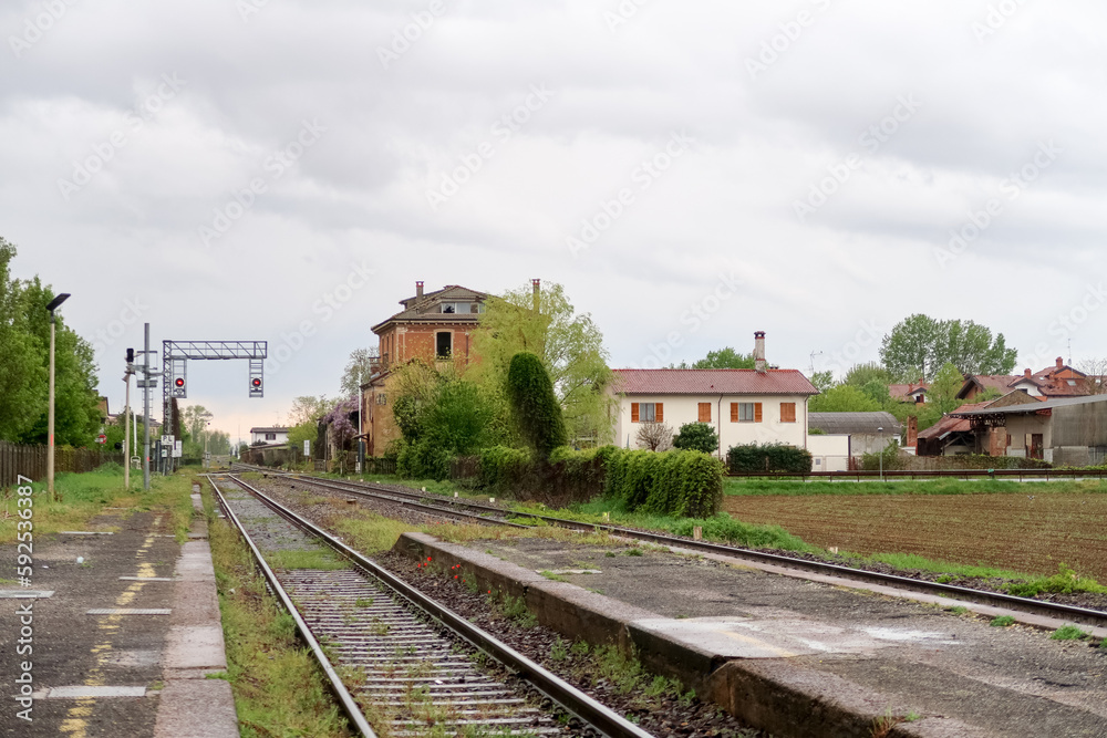 Naklejka premium Station train railway panorama landscape characteristic tracks house building cloud