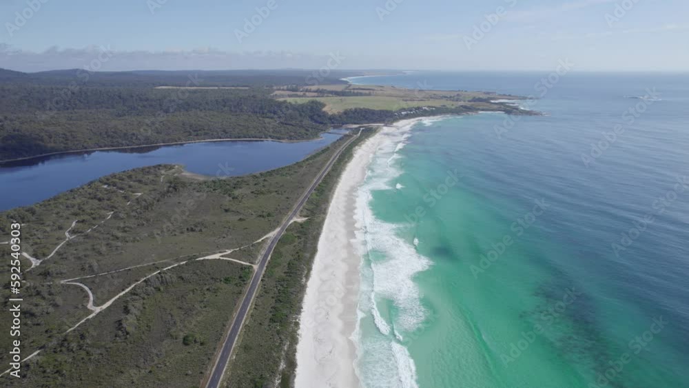 Gardens Road Along Taylors Beach And Big Lagoon In Tasmania, Australia. aerial pullback Gardens Road Along Taylors Beach And Big Lagoon In Tasmania, Australia. aerial pullback