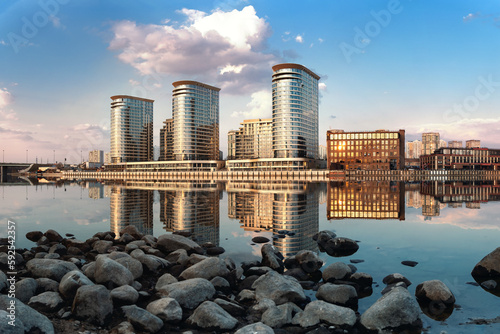 Canvas Print View of modern buildings on the river bank in the Moscow district with stones in