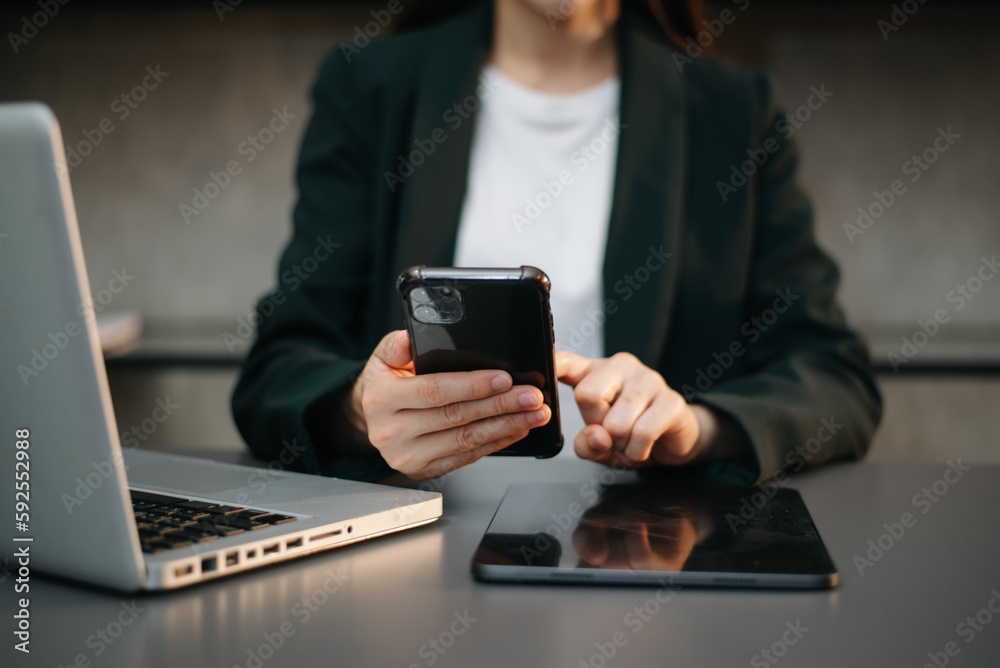 Businesswoman hand using laptop, tablet and smartphone in office. Digital marketing media mobile app and discussing plan new start up project. Businesswoman hand using laptop, tablet and smartphone in office. Digital marketing media mobile app and discussing plan new start up project.