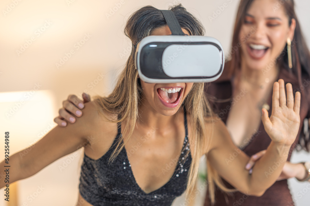 Excited friends playing with virtual reality goggles Excited friends playing with virtual reality goggles