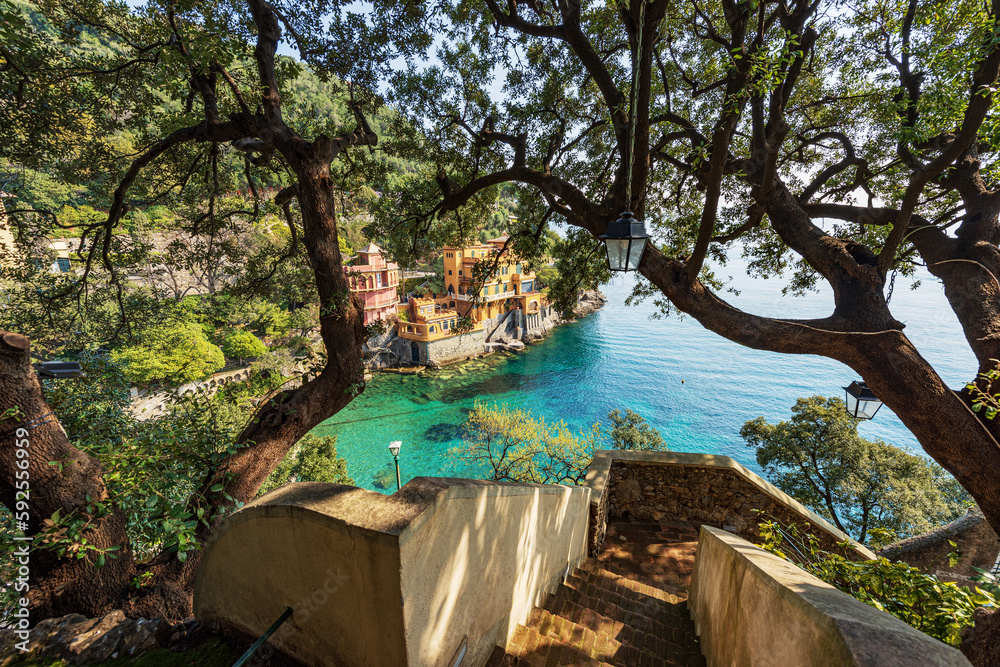 Bay and beach of Paraggi near the Portofino village. Tourist resort in Genoa Province (Genova), Liguria, Italy, Europe. Coast and Mediterranean Sea (Ligurian Sea). Bay and beach of Paraggi near the Portofino village. Tourist resort in Genoa Province (Genova), Liguria, Italy, Europe. Coast and Mediterranean Sea (Ligurian Sea).