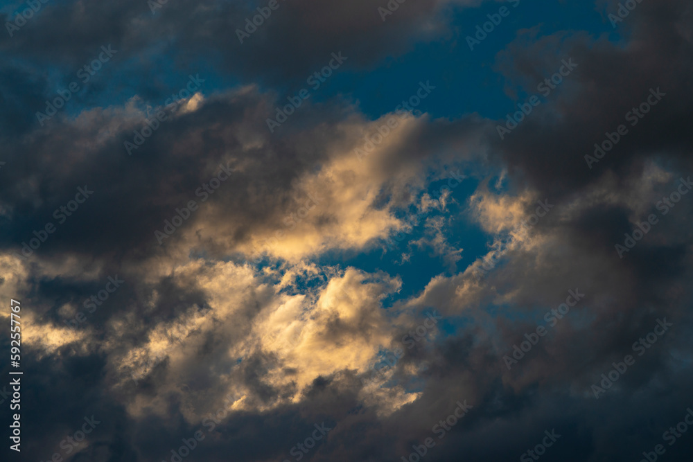 Beautiful dramatic sky with sunbeams through the clouds at sunset