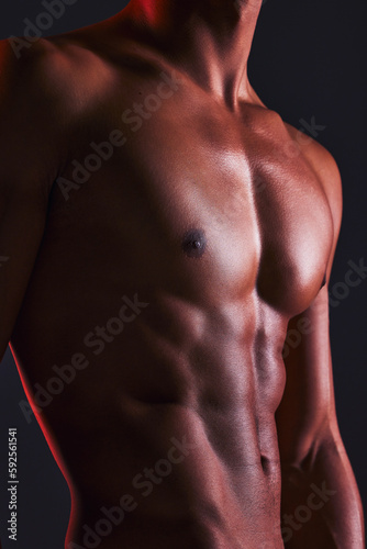 Beauty, closeup and abs of man in studio for fitness, muscle and bodybuilder. Natural, workout and diet with abdomen of male model on black background for six pack, exercise and training © Joshua A./peopleimages.com