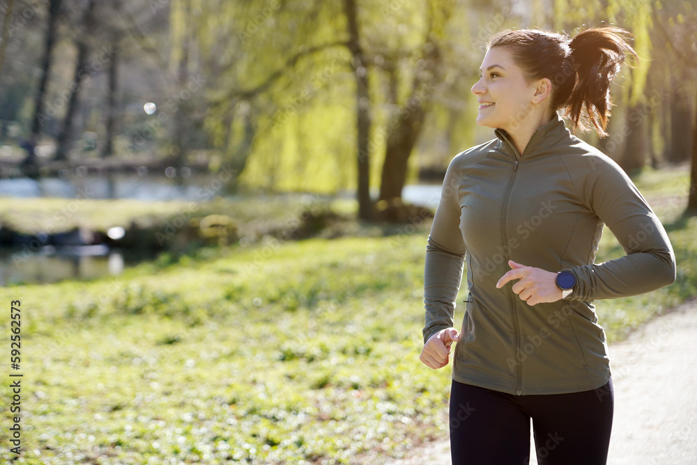 Sporty woman in sports wear jogging, running and training outdoors on a sunny morning
Sporty woman in sports wear jogging, running and training outdoors on a sunny morning