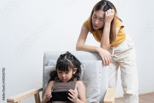 Asian mother feeling worried her daughter game addiction.
