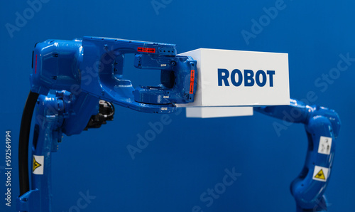 Robot arm with box and text ROBOT. Smart industry concept 