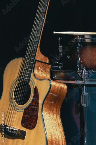 Acoustic guitar and snare drum on a black background isolated.