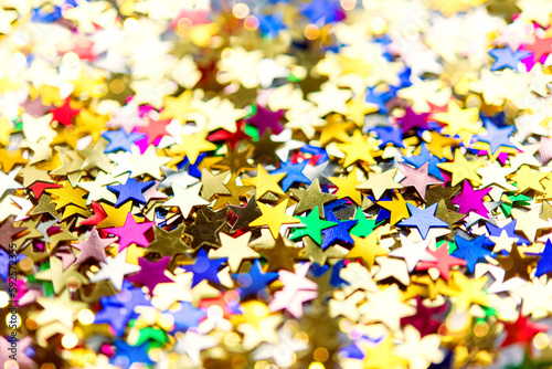 Multi-colored shining stars close-up. Festive holiday background. 