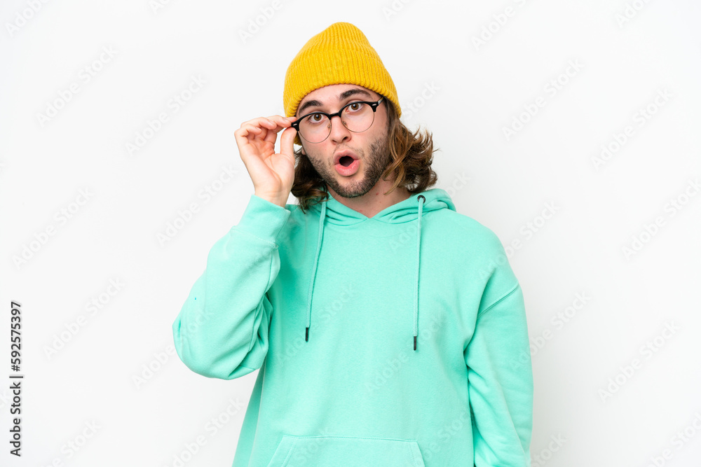 Young handsome man isolated on white chroma background with glasses and surprised Young handsome man isolated on white chroma background with glasses and surprised