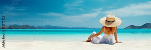 Woman with straw hat sunbathing on tropical beach