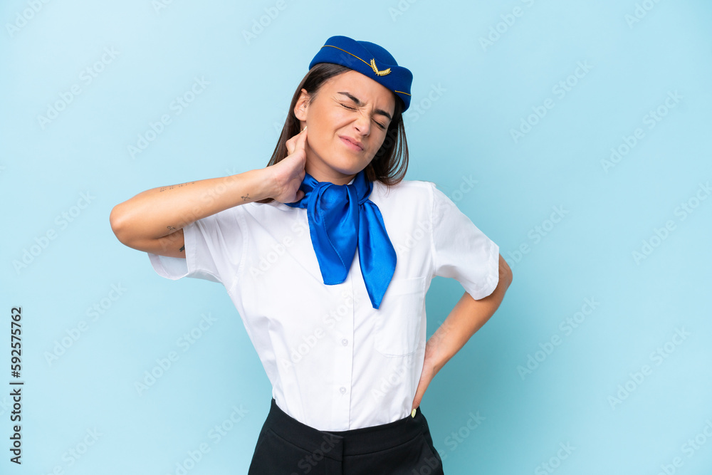 Airplane stewardess caucasian woman isolated on blue background with neckache Airplane stewardess caucasian woman isolated on blue background with neckache