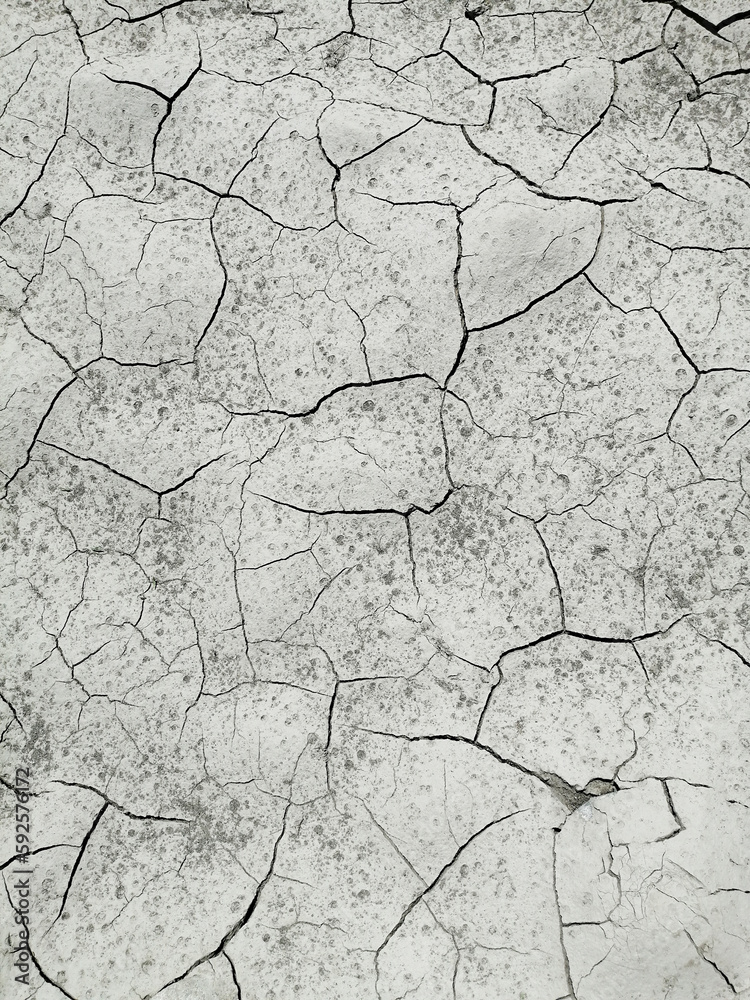 Dry, cracked earth, top view for background or graphic design with drought concept. Dry, cracked earth, top view for background or graphic design with drought concept.
