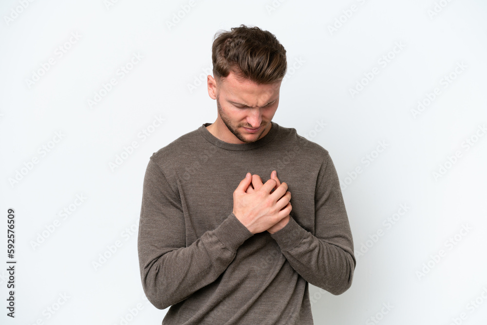 Young blonde caucasian man isolated on white background having a pain in the heart Young blonde caucasian man isolated on white background having a pain in the heart