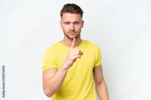 Young blonde caucasian man isolated on white background frustrated and pointing to the front