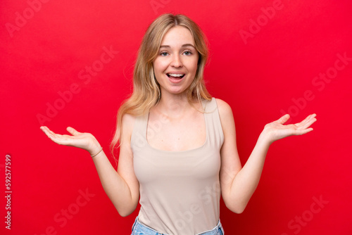 Young English woman isolated on red background with shocked facial expression © luismolinero