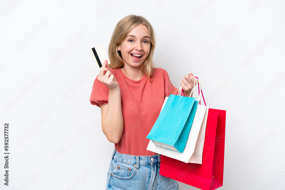 Fototapeta premium Young English woman isolated on white background holding shopping bags and a credit card