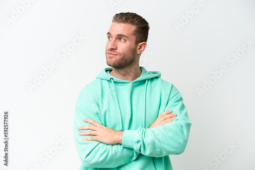 Young handsome caucasian man isolated on white background looking to the side
