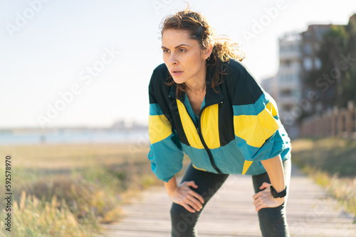 Young woman at outdoors wearing sport wear © luismolinero