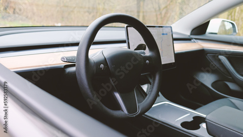 Interior dashboard with a modern interface design and steering wheel.  © Yuliya