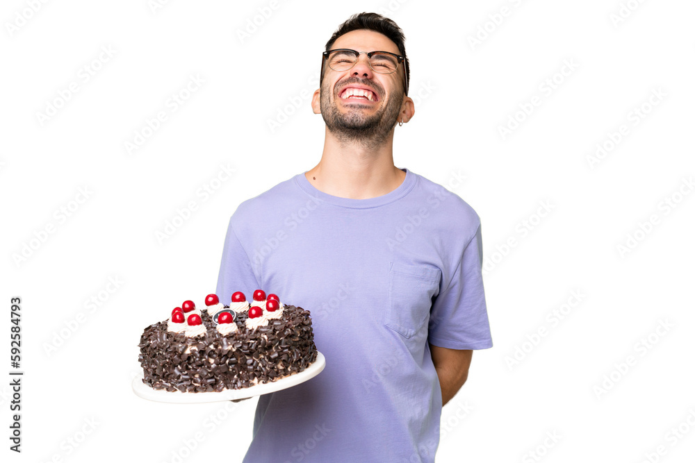 Young caucasian man holding birthday cake isolated on green chrome background laughing Young caucasian man holding birthday cake isolated on green chrome background laughing