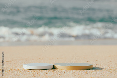 Two empty round platform podiums on the beach sand