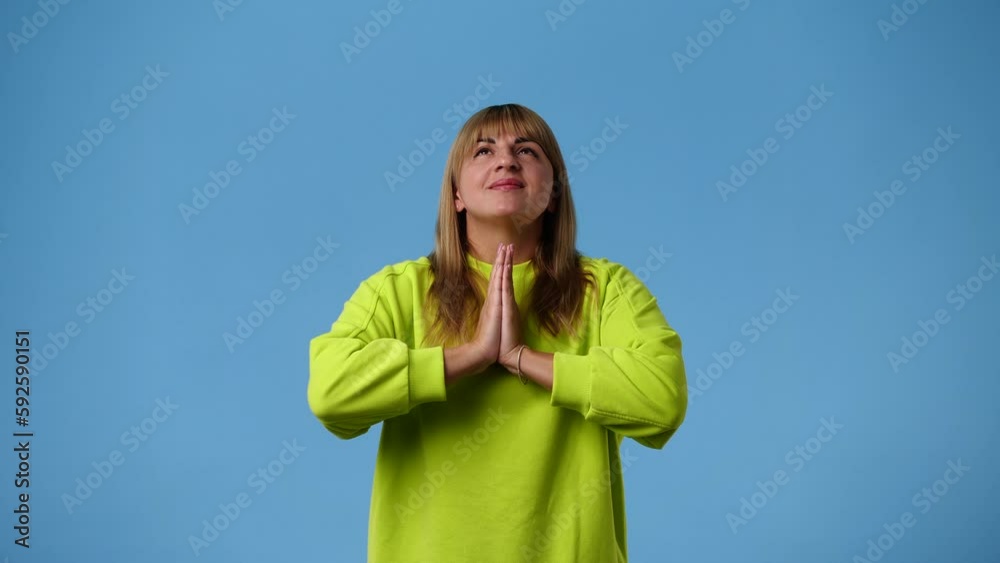 4k video of one woman who pleading over blue background. 4k video of one woman who pleading over blue background.