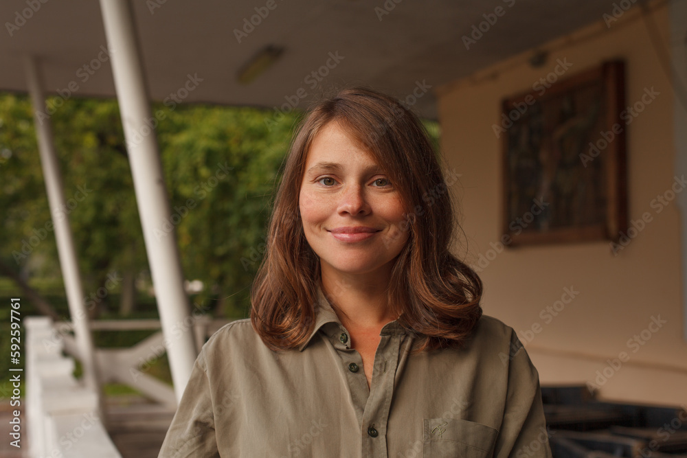 Cute woman with curly brown hair outdoors Cute woman with curly brown hair outdoors