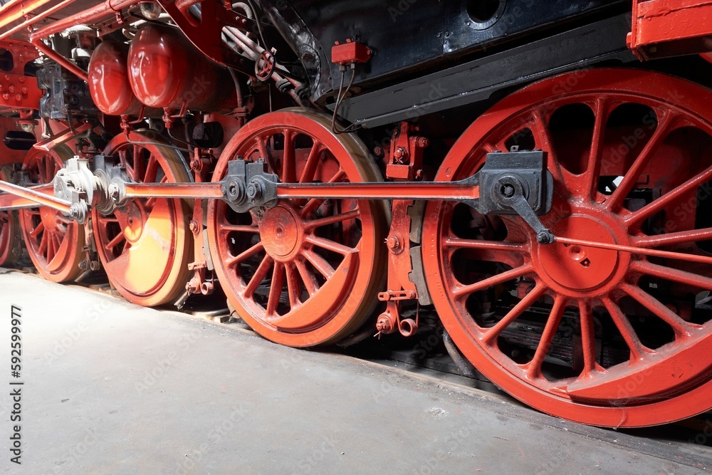 Closeup of red steam wheels on a locomotive