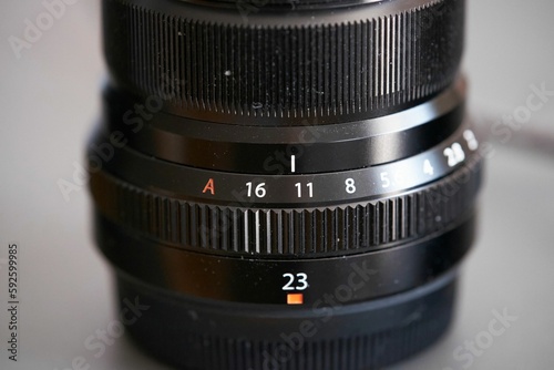 Closeup of a camera lens on a white surface photo