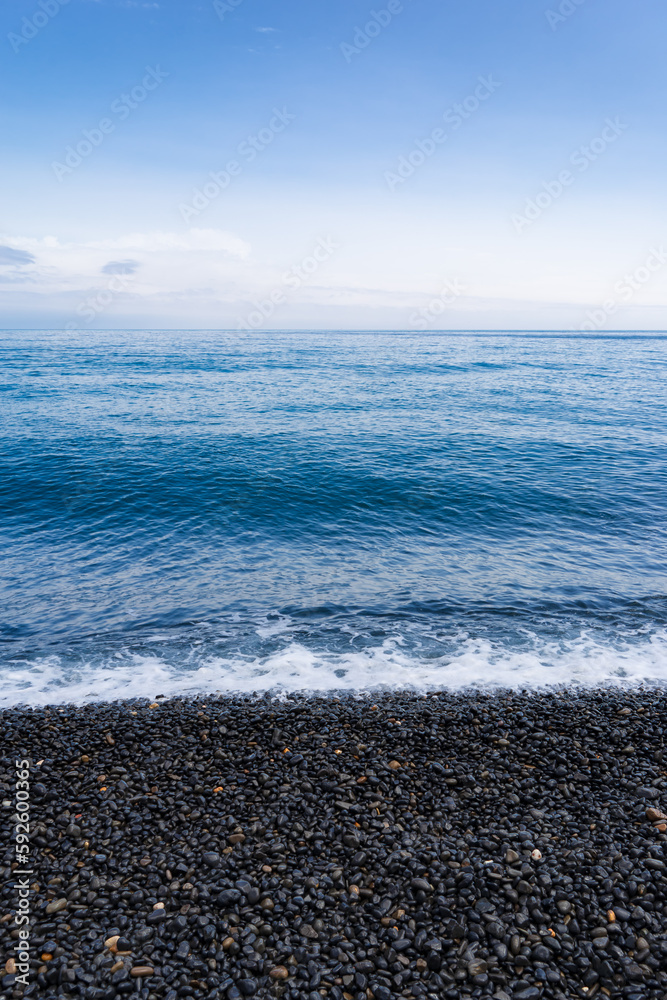 Vertical shot of Mavra Volia beach on the Greek island of Chios in Greece Vertical shot of Mavra Volia beach on the Greek island of Chios in Greece