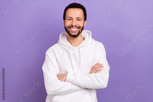 Photo of cheerful friendly person beaming smile crossed arms isolated on violet color background