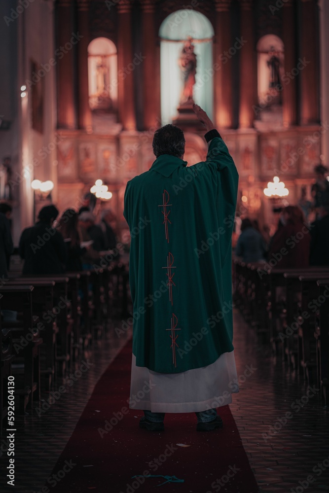 Vertical shot of a priest during the mass at church