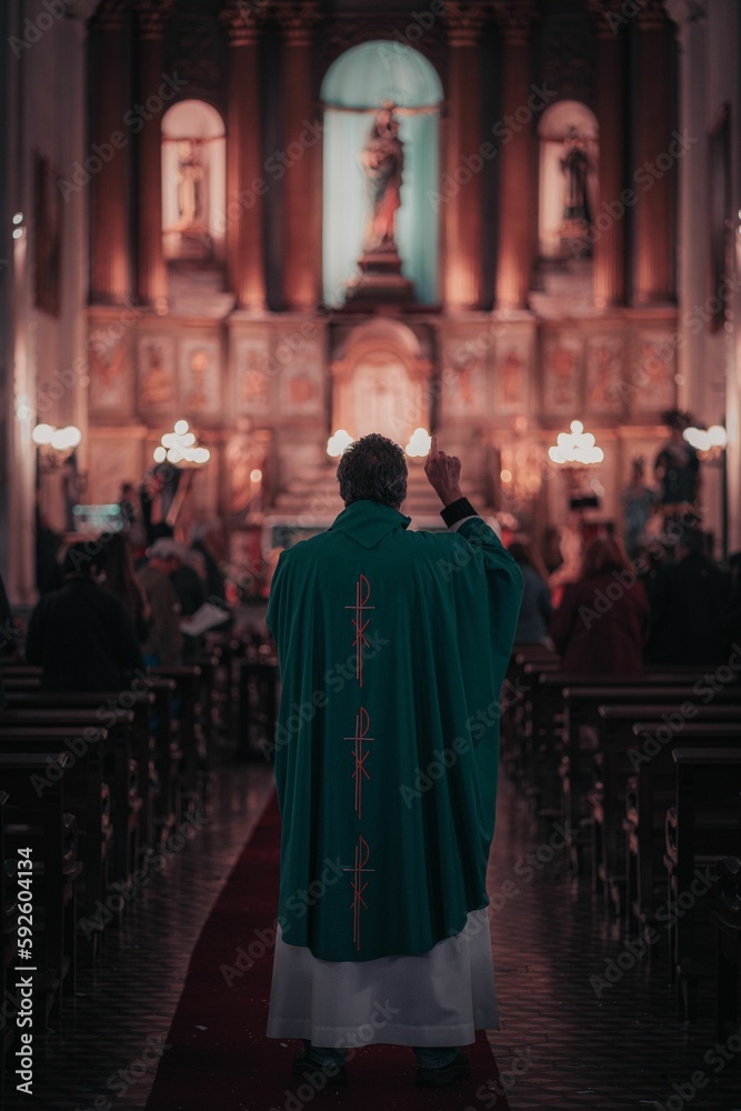 Vertical shot of a priest during the mass at the Catholic church