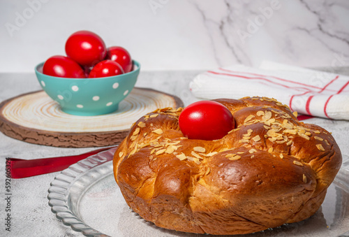 Easter traditional bread, greek tsoureki and red eggs on a table 