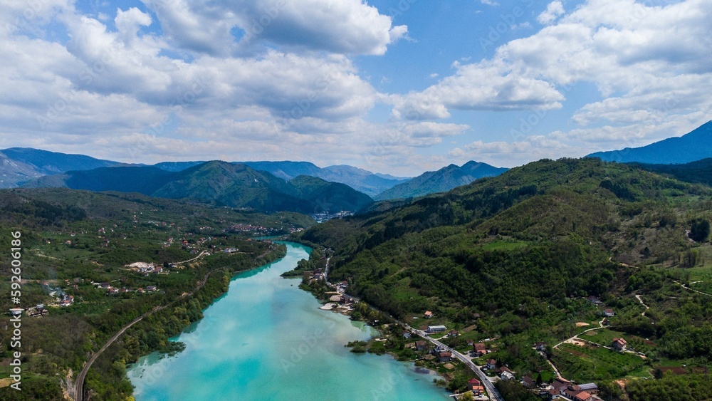 Bird's eye view of an azure river between villages on mountains in Bosnia and Herzegovina