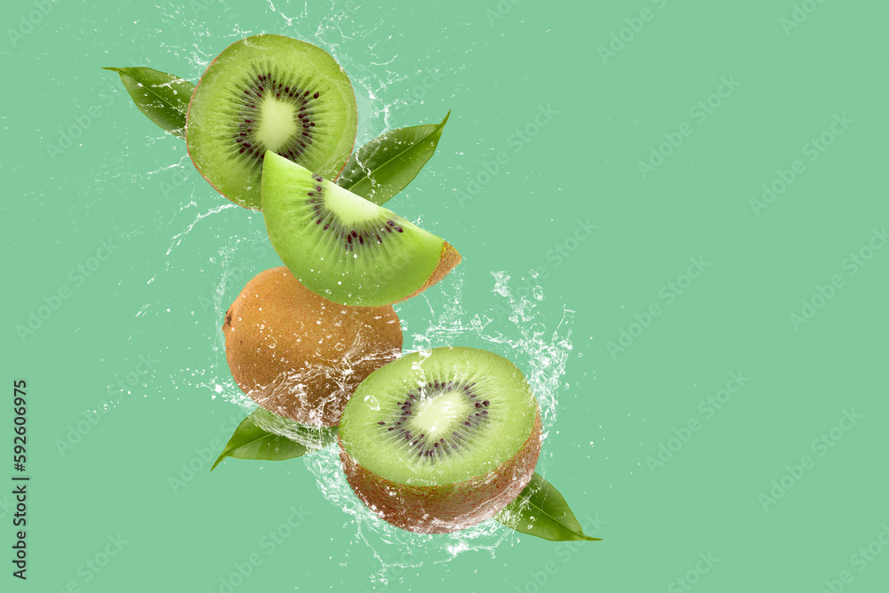 Creative layout made from Sliced of kiwi and water Splashing on a green background. - obrazy, fototapety, plakaty 