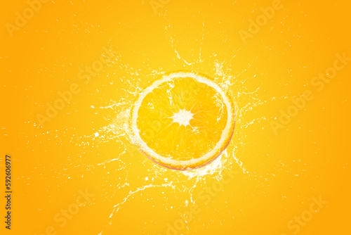 Creative layout made from Fresh Sliced oranges and Orange fruit and water Splashing on a orange background.