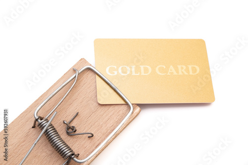 Gold credit card on a mousetrap, Financial trap, Debt, Financial problems.