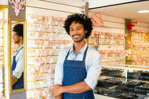 Owner poses for portrait in jewelry store. photo