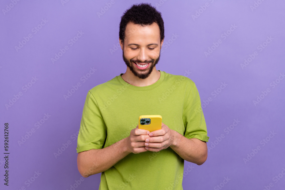 Portrait of positive person use smart phone typing write post comment isolated on purple color background Portrait of positive person use smart phone typing write post comment isolated on purple color background