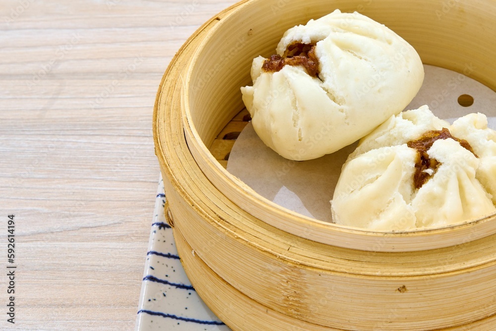 Closeup of Char siu bao in a wooden bowl. Chinese cuisine. Closeup of Char siu bao in a wooden bowl. Chinese cuisine.