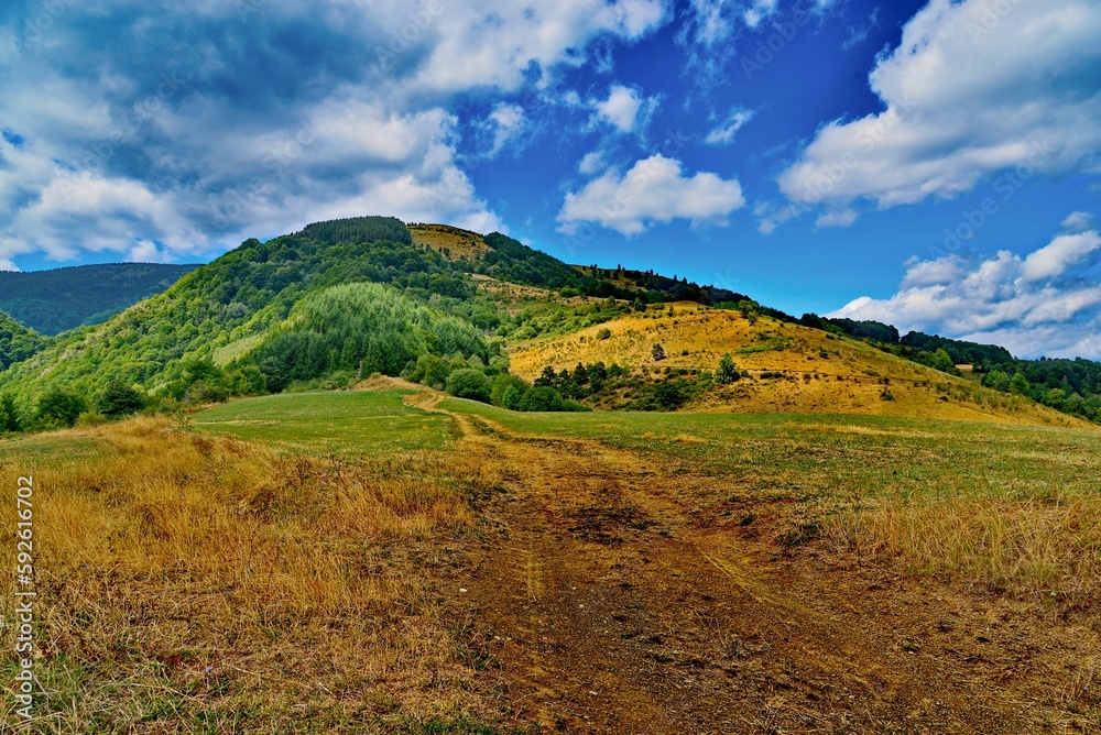 Scenic view of a hill under the beautiful blue sky